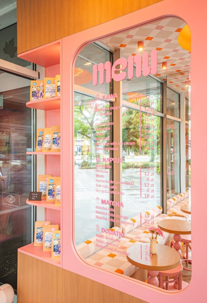 Ma Ma Cafe menu on the glass and shelves of whole bean coffee