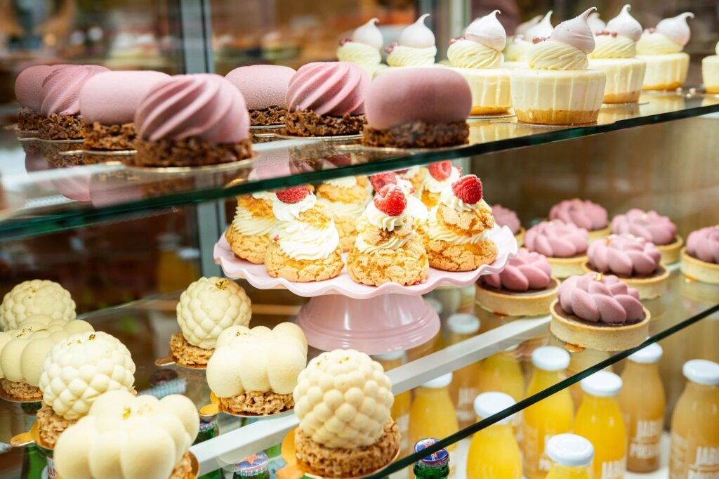 Individual desserts and raspberry choux buns in the Ma Ma Cafe display in Swinoujscie