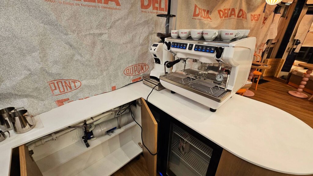 Installing the Nuova Simonelli Appia Life Compact and Eureka grinder at Ma Ma Cafe, with the BRITA filter under the counter