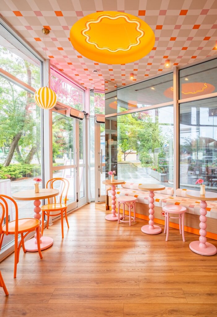Round orange neon ceiling light and checked ceiling at Ma Ma Cafe
